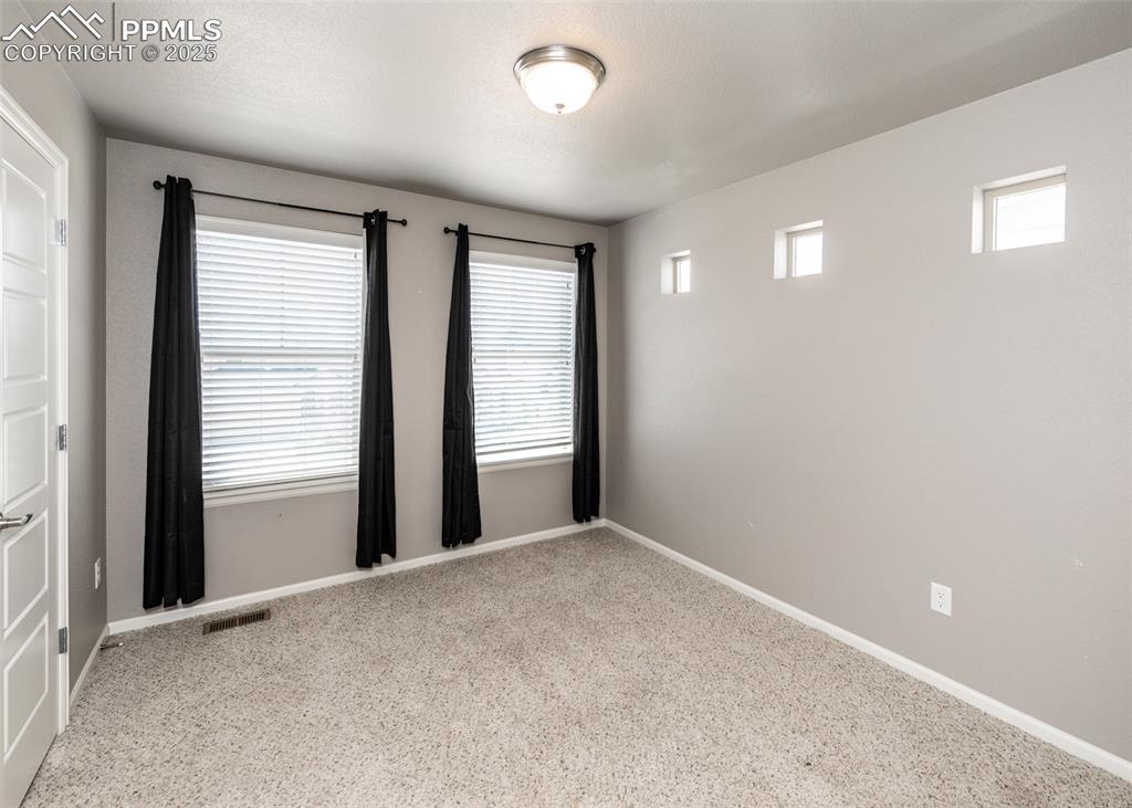 Image 37 of 40: Carpeted spare room with baseboards