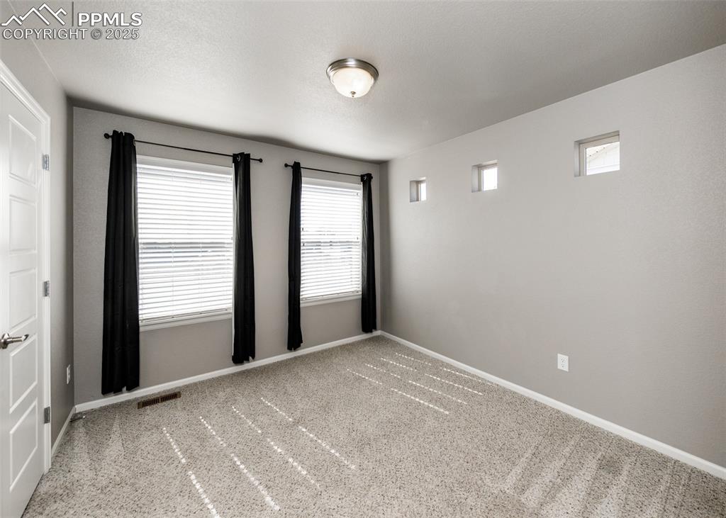 Image 42 of 50: Spare room featuring light colored carpet and baseboards