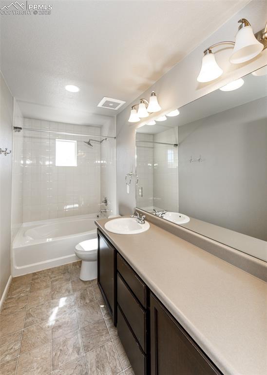 Image 46 of 50: Full bathroom featuring tub / shower combination, vanity, and a textured ce