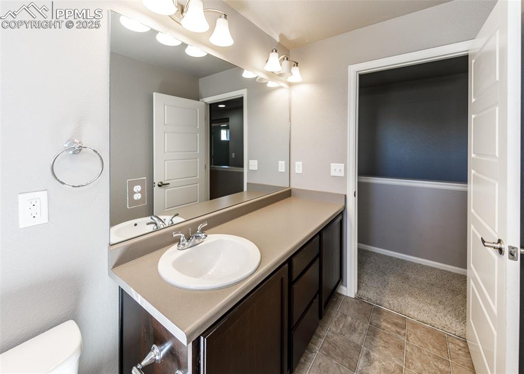 Image 47 of 50: Bathroom with vanity and toilet