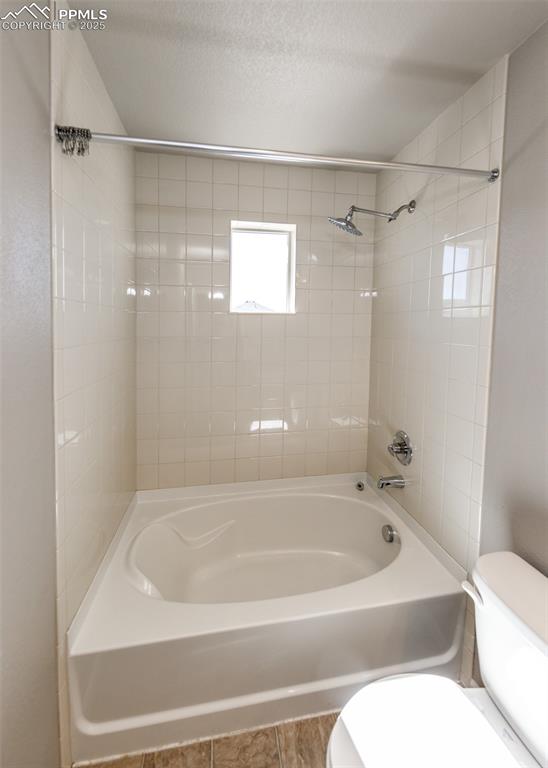 Image 48 of 50: Full bath featuring bathing tub / shower combination, a textured ceiling, a