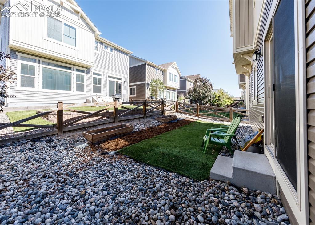 Image 50 of 50: View of yard with a vegetable garden and a residential view
