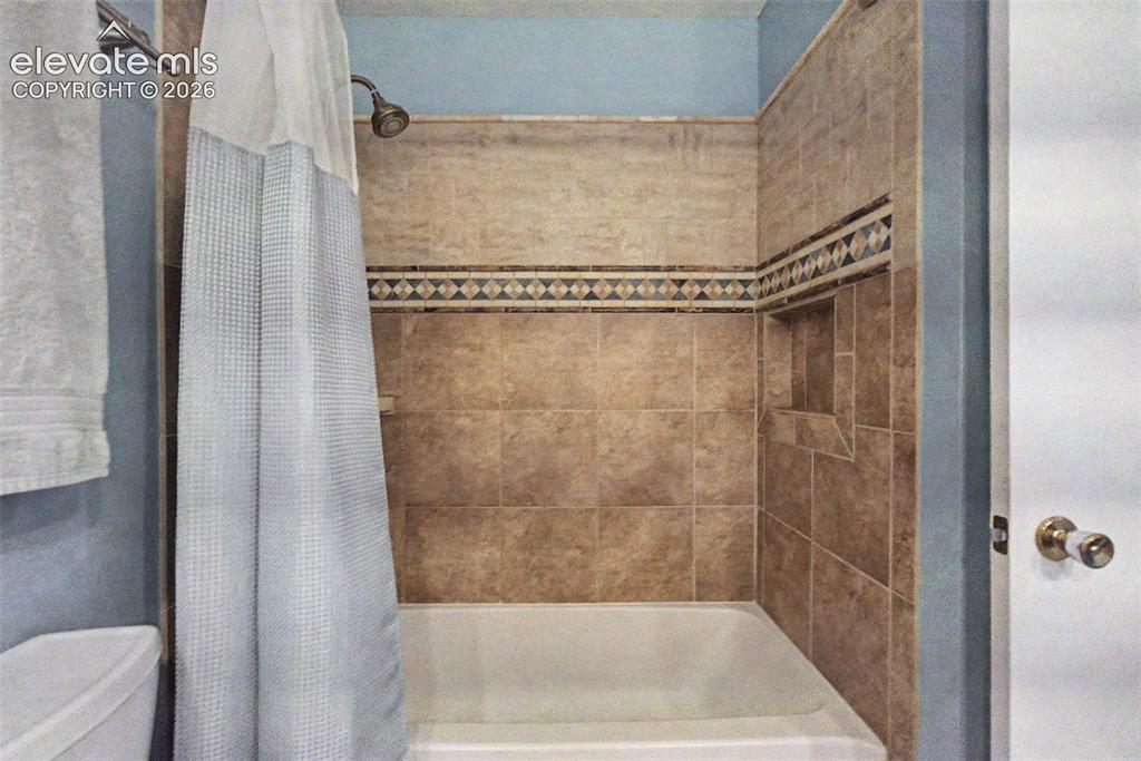 Image 27 of 49: Secondary Bath with Tub/ Shower