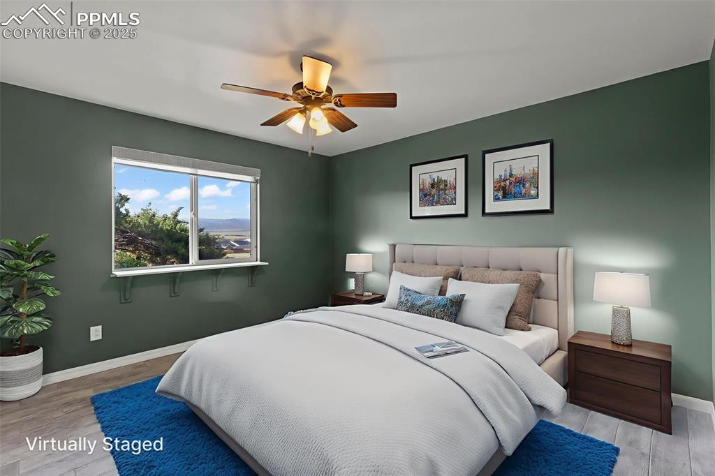 Image 15 of 27: Bedroom featuring wood finished floors and a ceiling fan