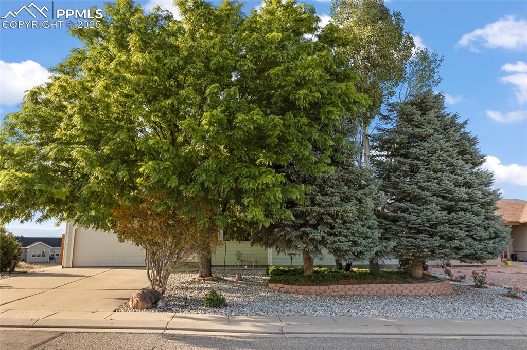 Image 2 of 27: Obstructed view of property with driveway and a garage