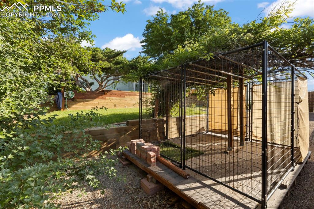 Image 23 of 27: View of yard featuring an exterior structure and an outbuilding