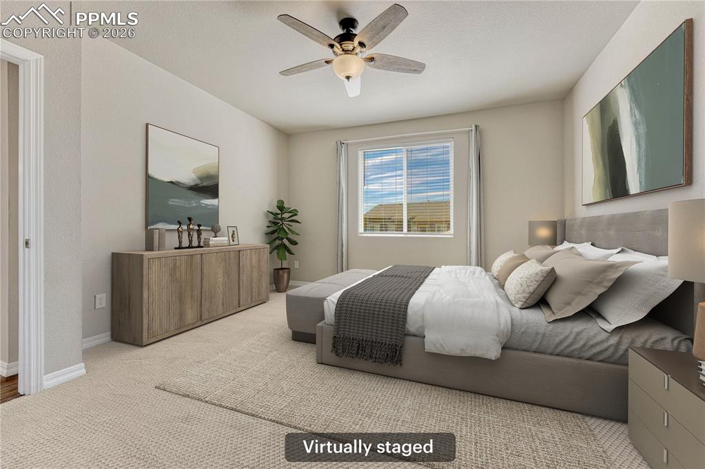 Image 13 of 42: The property features a bright room with carpeted flooring, a window offeri