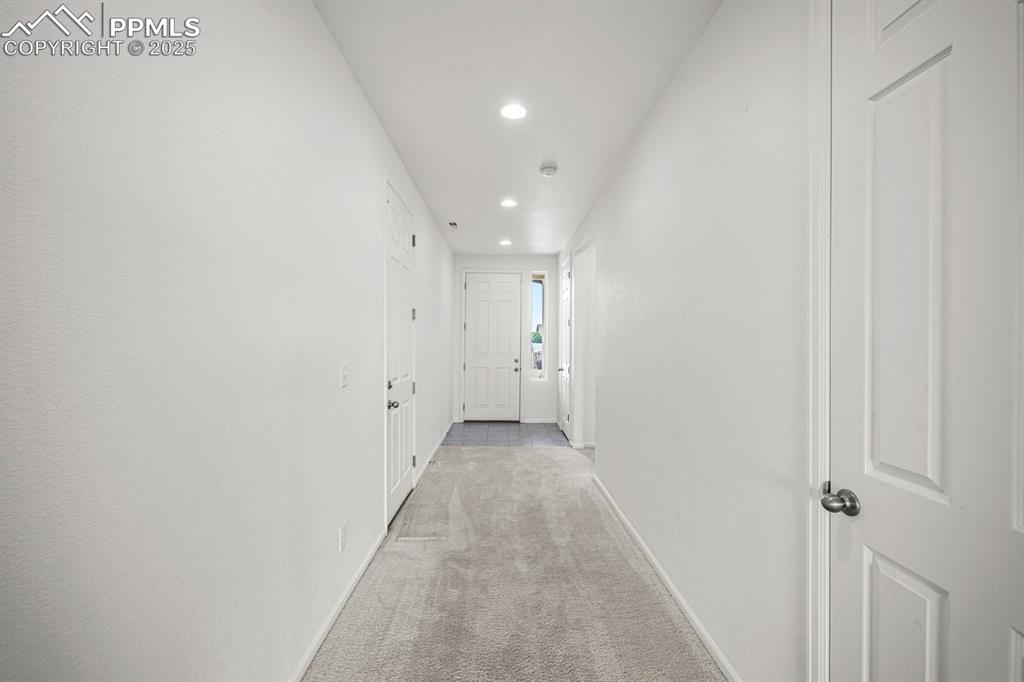 Image 4 of 25: Hall featuring recessed lighting and light carpet