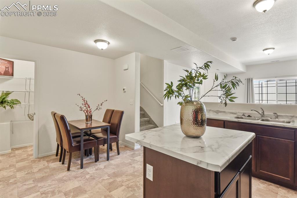 Image 13 of 36: Kitchen with island, dining area and view of separate pantry