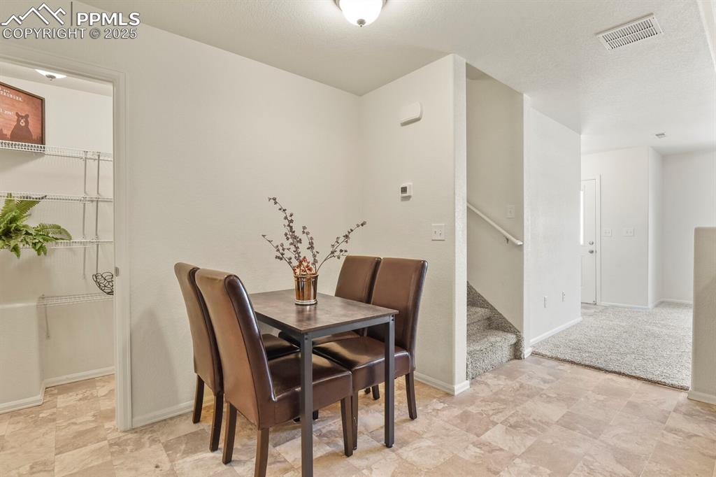 Image 16 of 36: Dining area and view of separate pantry