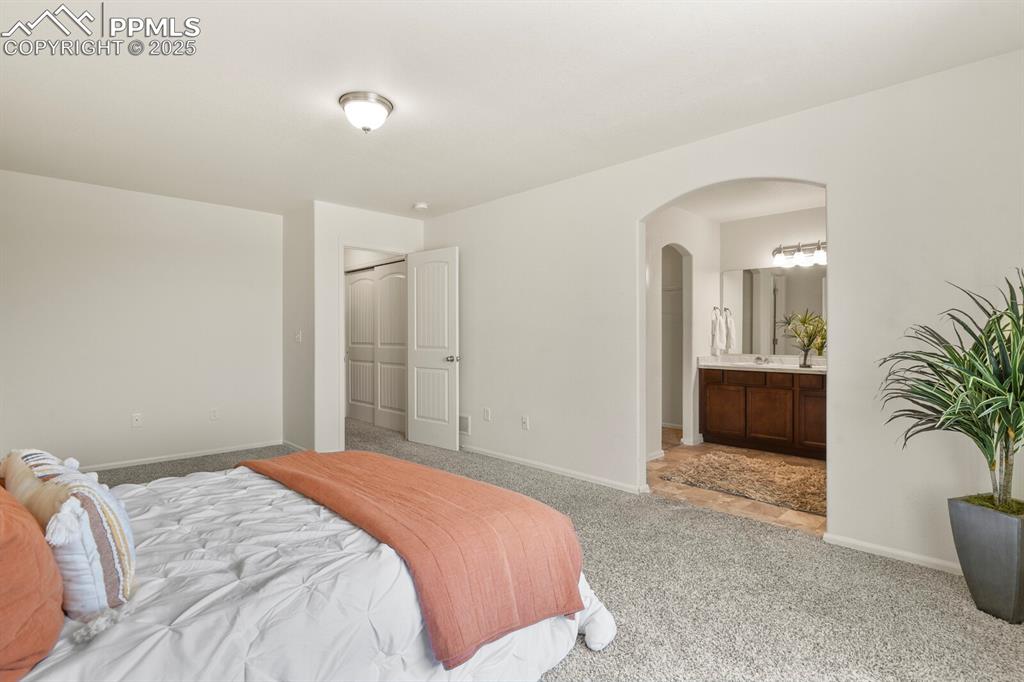 Image 21 of 36: Master Bedroom with Master Bath