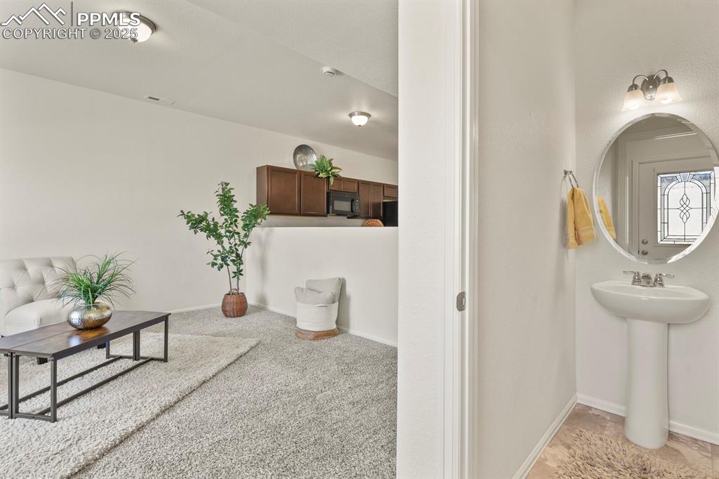 Image 9 of 36: Living Room with view of main floor bath