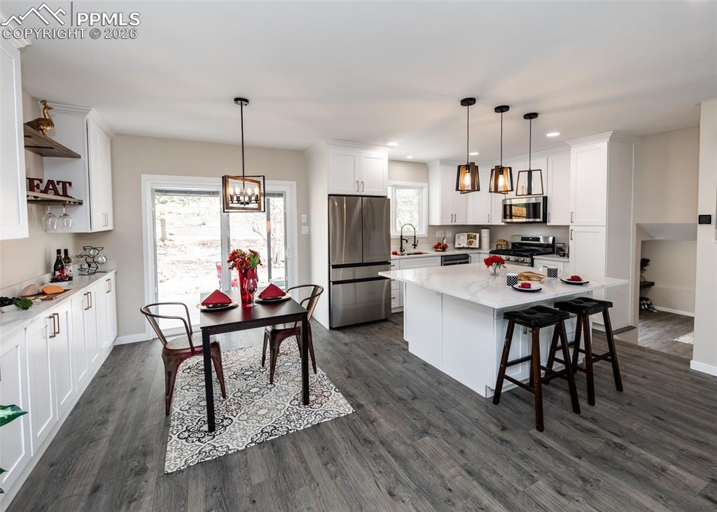 Image 18 of 48: Kitchen featuring white cabinetry, appliances with stainless steel finishes