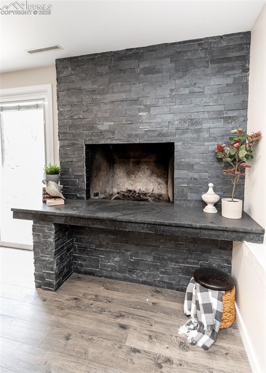 Image 34 of 48: Detailed view of wood finished floors and a fireplace