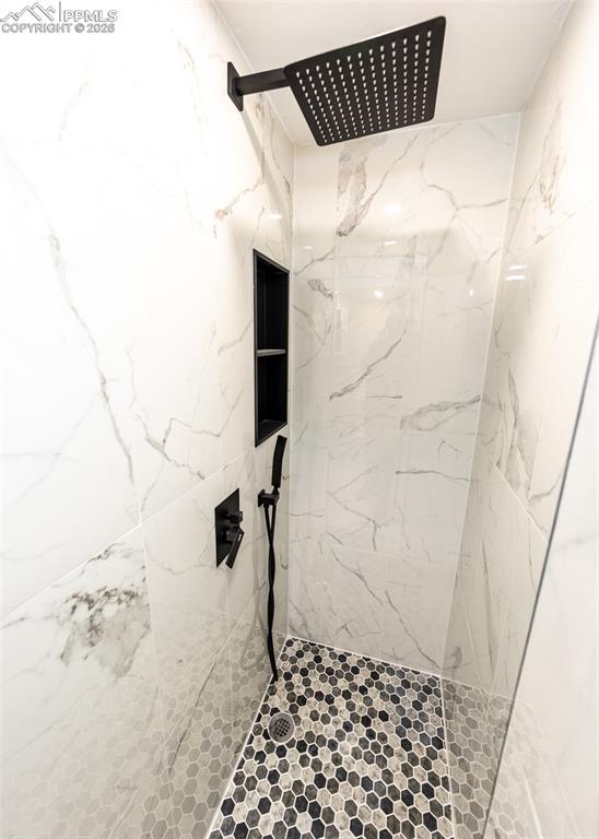 Image 39 of 48: Bathroom featuring a marble finish shower