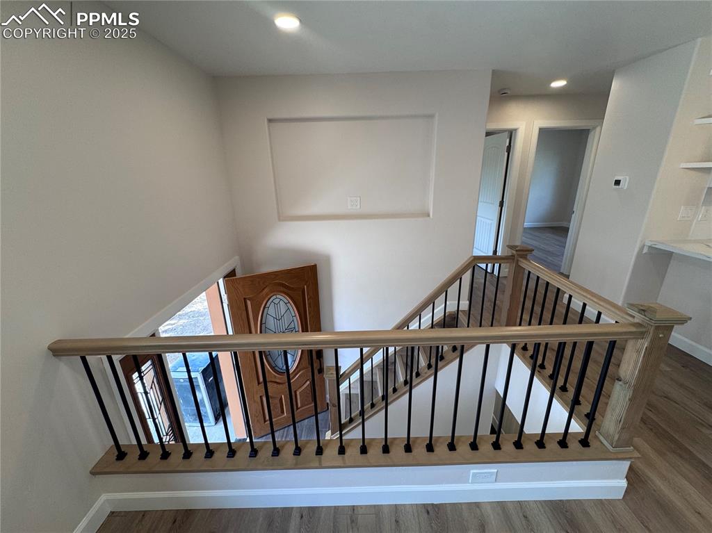 Image 11 of 36: Stairs with wood finished floors and recessed lighting