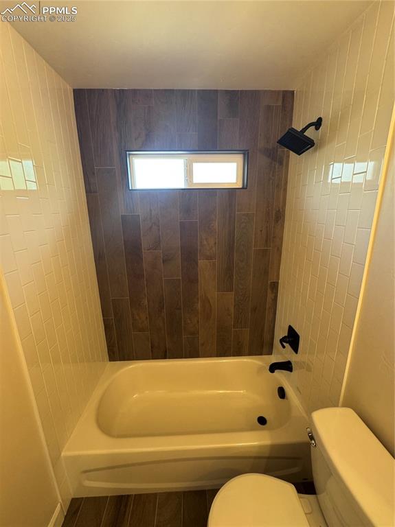 Image 16 of 36: Full bathroom with toilet and bathing tub / shower combination