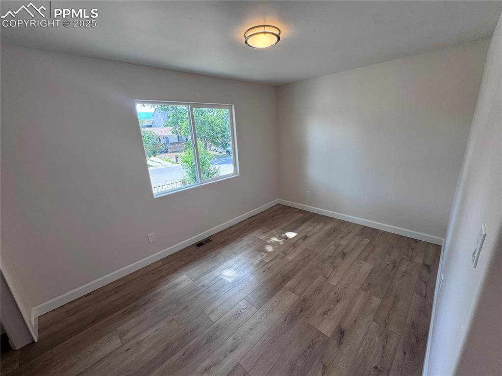Image 19 of 36: Unfurnished room featuring baseboards and light wood-style flooring
