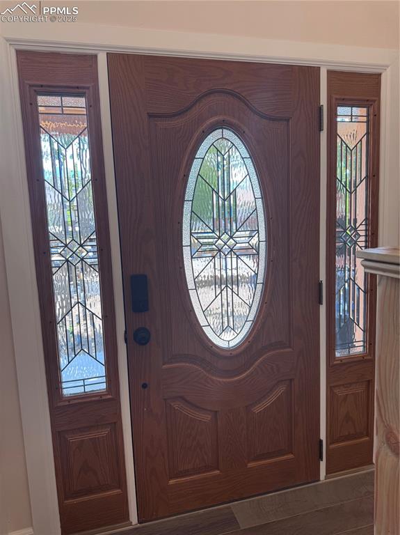 Image 21 of 36: Foyer entrance with plenty of natural light and wood finished floors