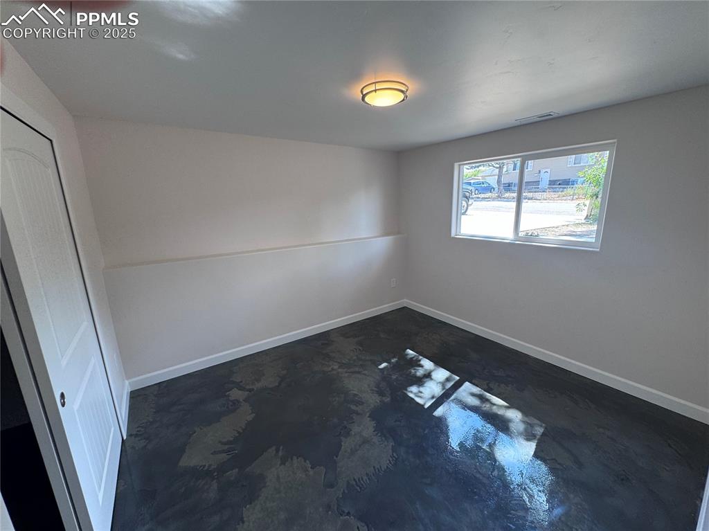 Image 24 of 36: Spare room featuring concrete flooring and baseboards