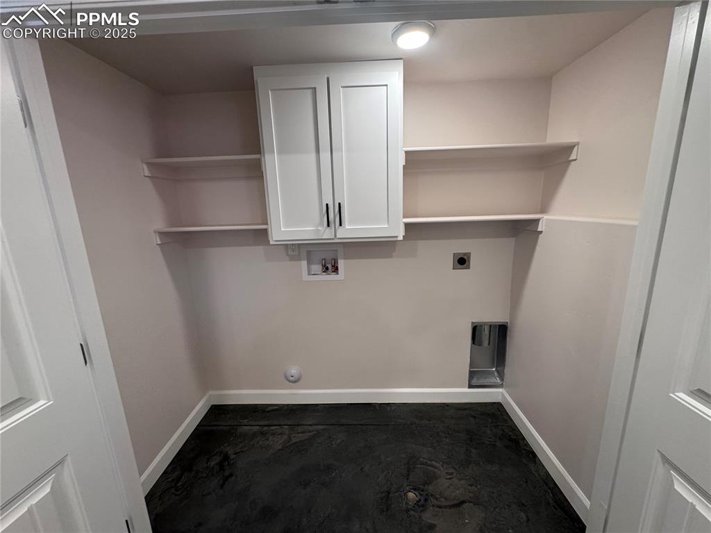 Image 36 of 36: Laundry area featuring cabinet space, hookup for a washing machine, and ele