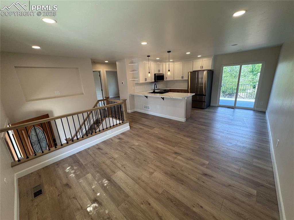 Image 4 of 36: Kitchen featuring open shelves, recessed lighting, white cabinetry, applian