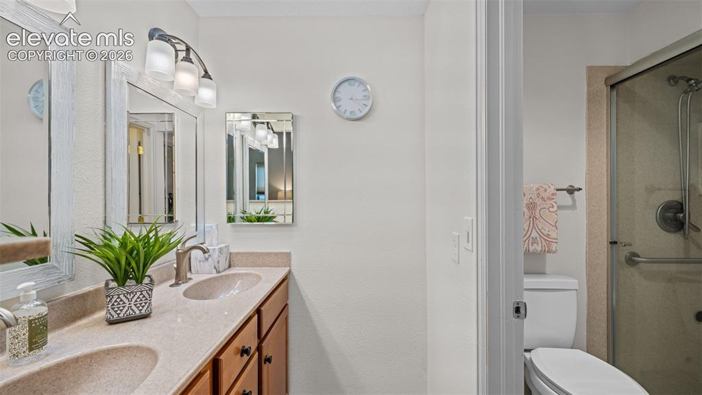 Image 15 of 50: Dual undermount sinks with brushed nickel faucets, set in a light-toned cou
