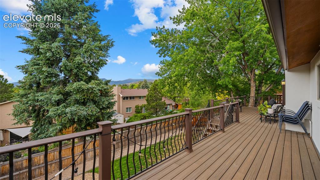 Image 17 of 50: Spacious outdoor deck featuring wood-finish flooring, dark decorative raili