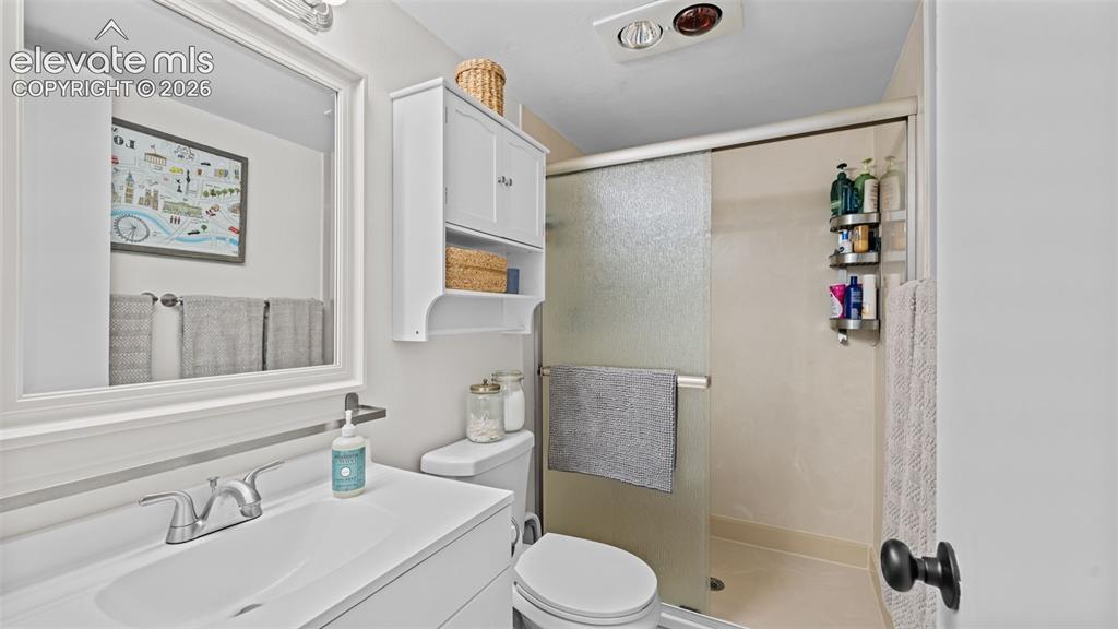 Image 35 of 50: Bathroom featuring a white vanity with integrated sink, chrome faucet, and 