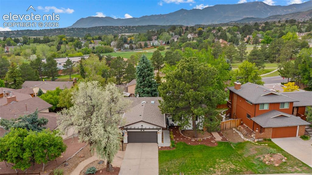 Image 41 of 50: Ranch-style residence featuring a dark asphalt shingle roof, attached two-c
