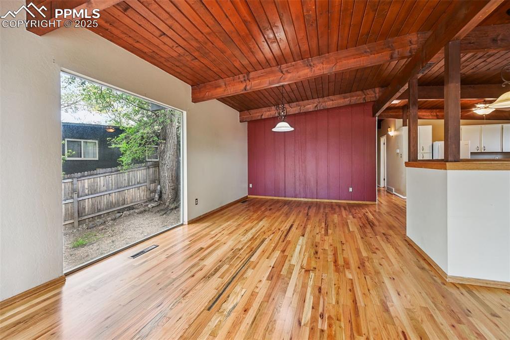 Image 8 of 44: Unfurnished room featuring wood finished floors and a wood ceiling with exp