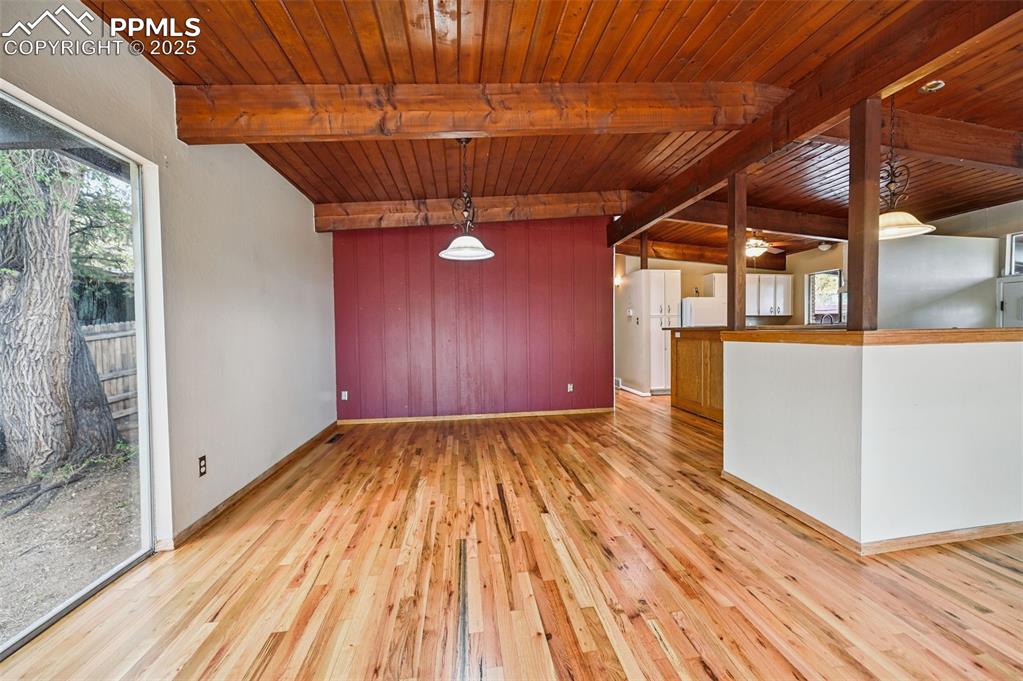 Image 9 of 44: Unfurnished living room with wooden ceiling and light wood finished floors