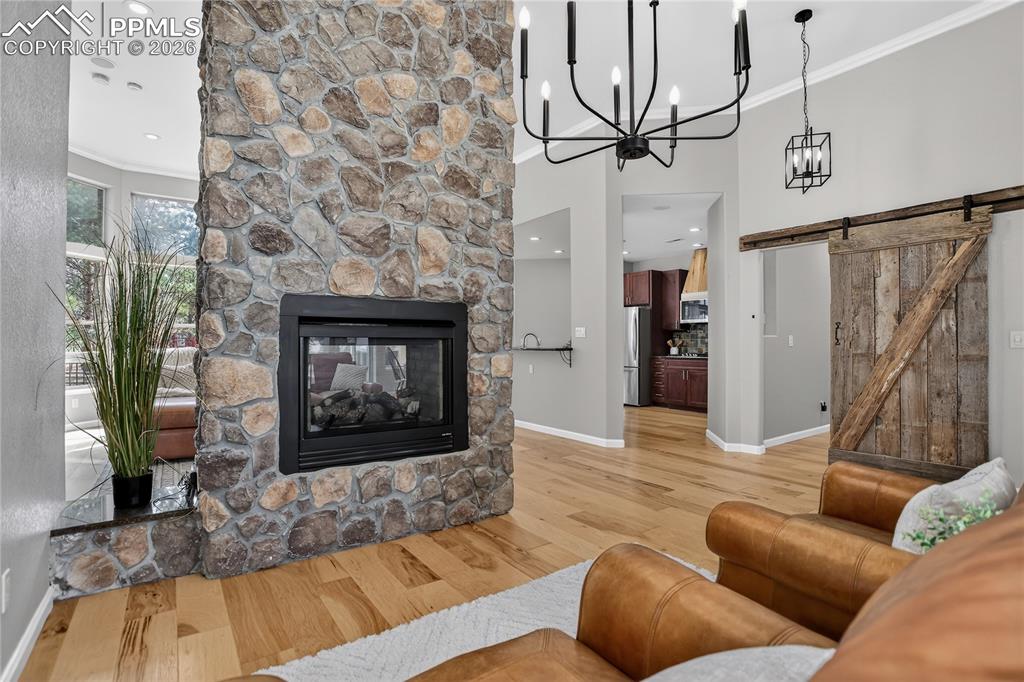 Image 6 of 35: Double sided fireplace shared by living room & family room