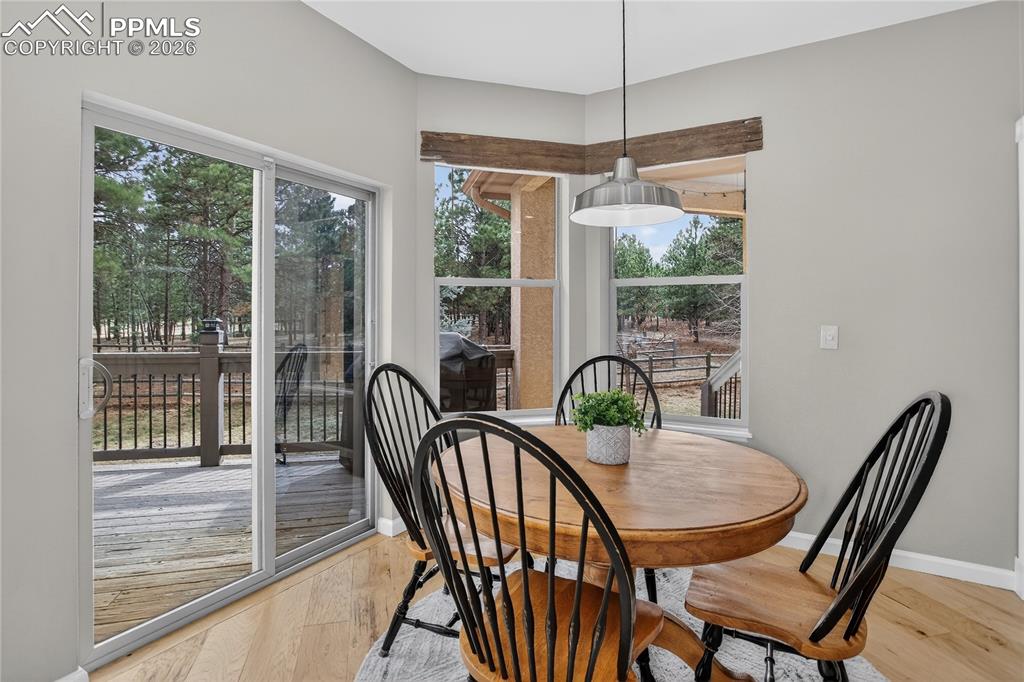 Image 9 of 35: Dining nook with walk-out to deck