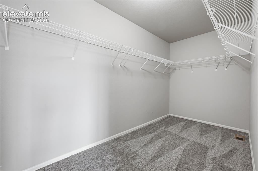Image 24 of 29: Spacious Primary Bedroom Walk-in Closet