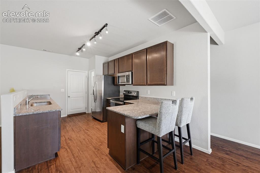 Image 7 of 29: Kitchen and breakfast bar