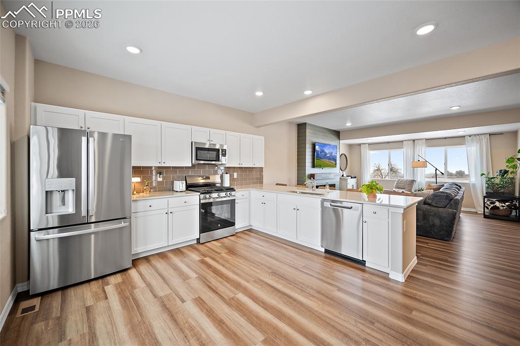 Image 5 of 47: Stainless steal appliances, quartz countertops and luxury vinyl flooring.