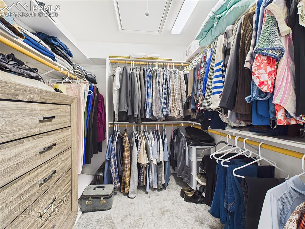 Image 27 of 49: Walk-In Closet – Expansive walk-in closet with built-in shelving, hanging s