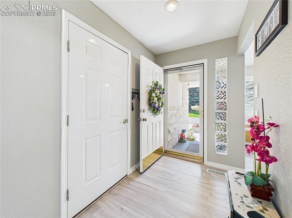 Image 3 of 49: Entry Foyer Covered entry opens into a welcoming foyer with natural light f