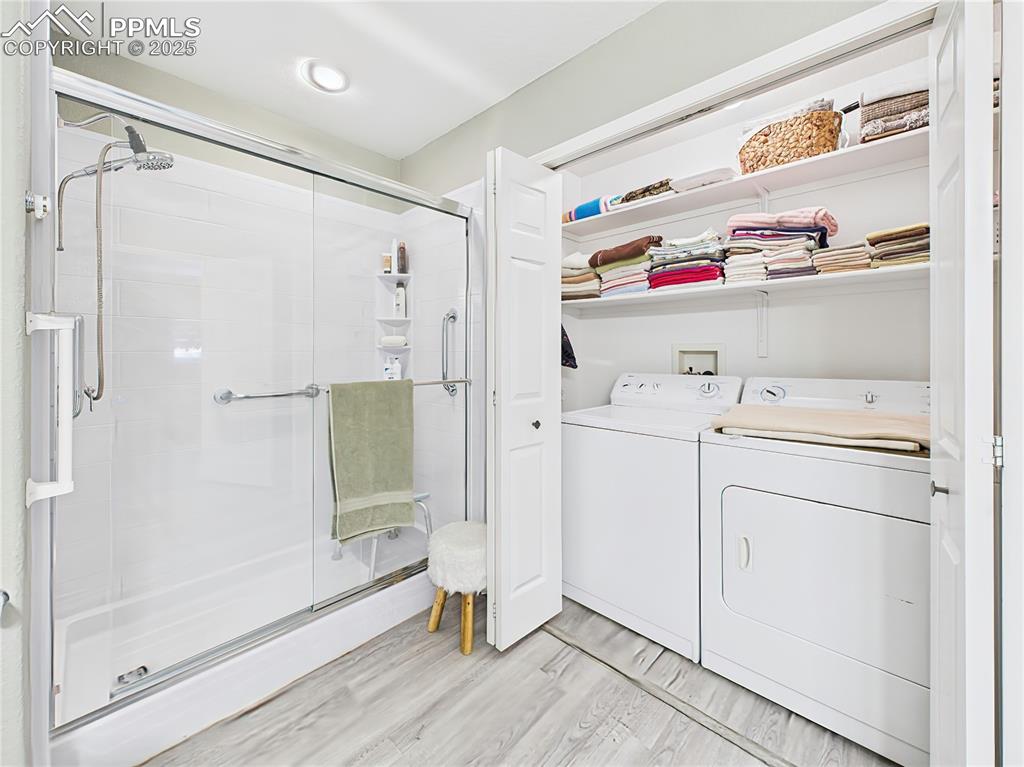 Image 33 of 49: Laundry & Shower Combo – Uniquely designed space with a large step-in showe