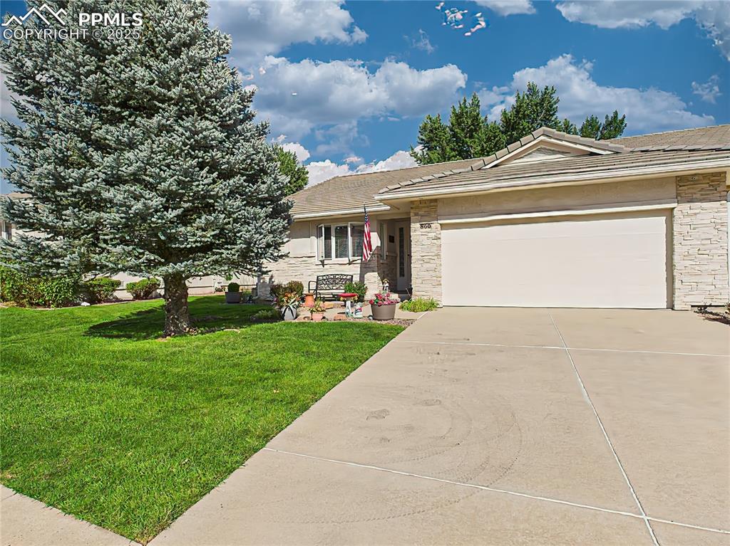 Image 34 of 49: Front Exterior – Crisp curb appeal with stone-accented exterior, well-maint