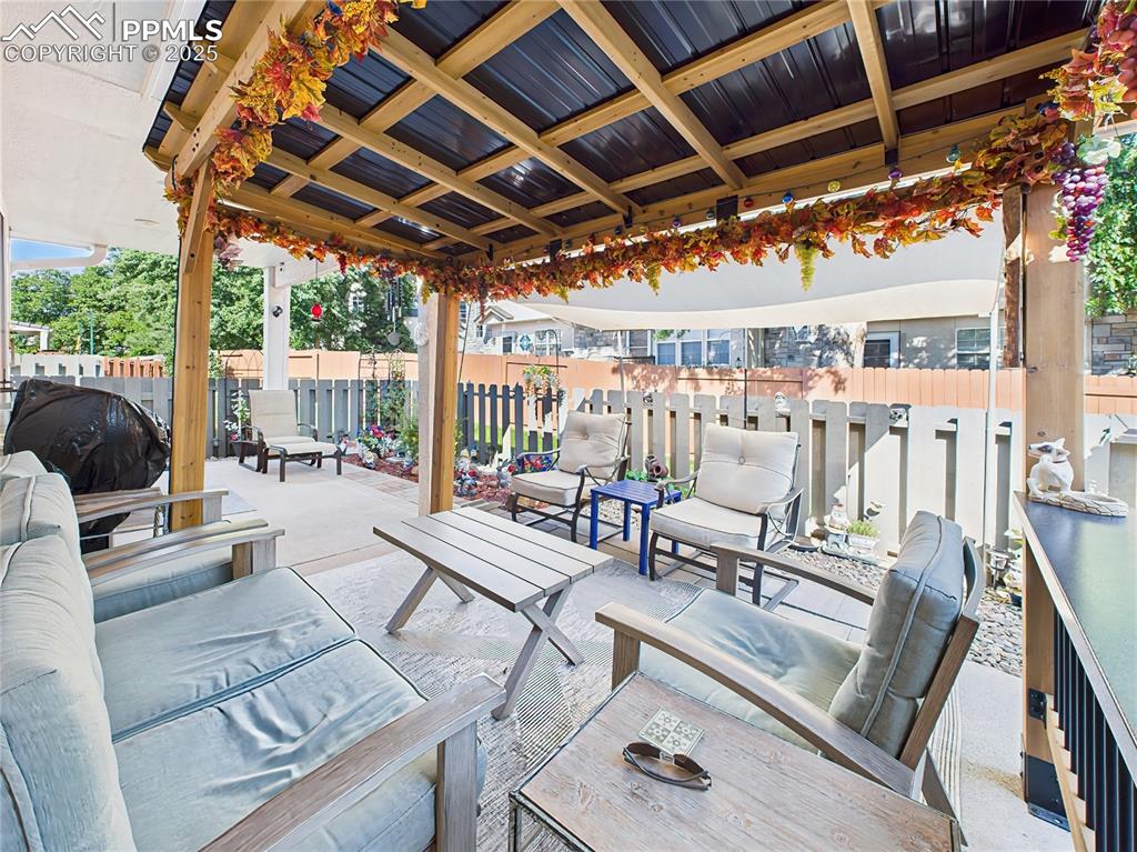 Image 41 of 49: Pergola & Sun Shade Seating Area – Inside the pergola, the cozy lounge area