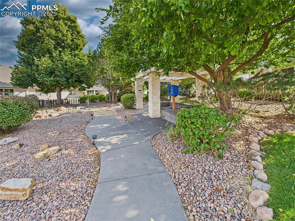 Image 44 of 49: Community Pavilion off Guest Parking – Tree-lined walkway leads to the pavi