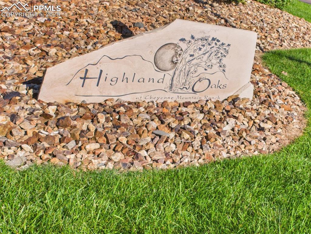 Image 46 of 49: Community Entry Sign – Stone monument sign welcomes residents to Highland O