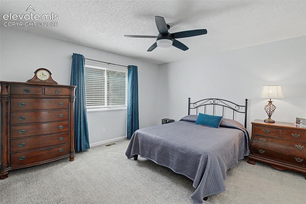 Image 13 of 36: Retreat to the primary suite featuring a walk-in closet and remodeled ensui