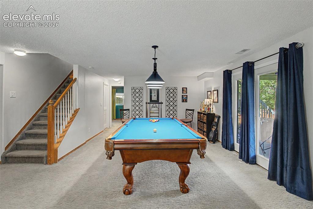 Image 21 of 36: The rec room also features a walk-out to the covered patio