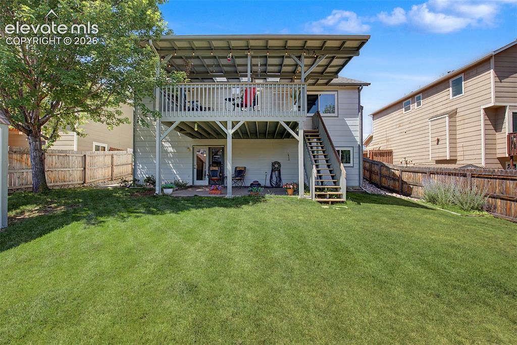 Image 29 of 36: The fully fenced and landscaped backyard features a storage shed and plenty