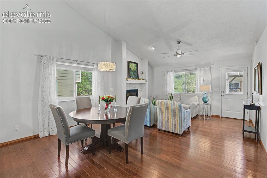 Image 9 of 36: The inviting dining and living areas feature an updated fireplace, vaulted