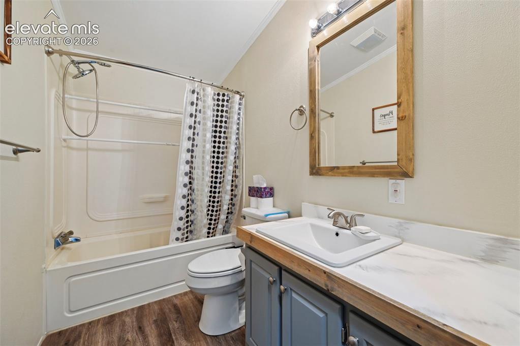 Image 17 of 36: Bathroom featuring a combination bathtub and shower, wood-finish flooring,