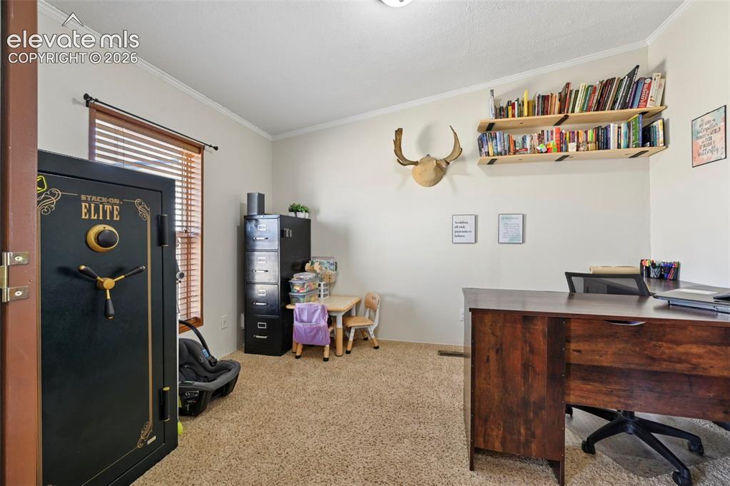 Image 22 of 36: Room with neutral-toned walls and crown molding